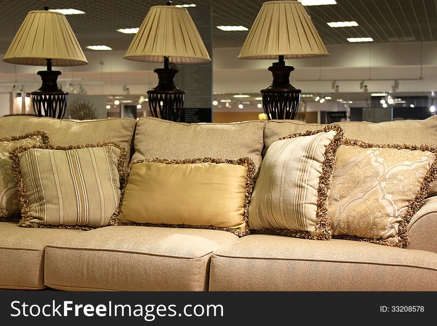 Lamps and modern sofa with pillows