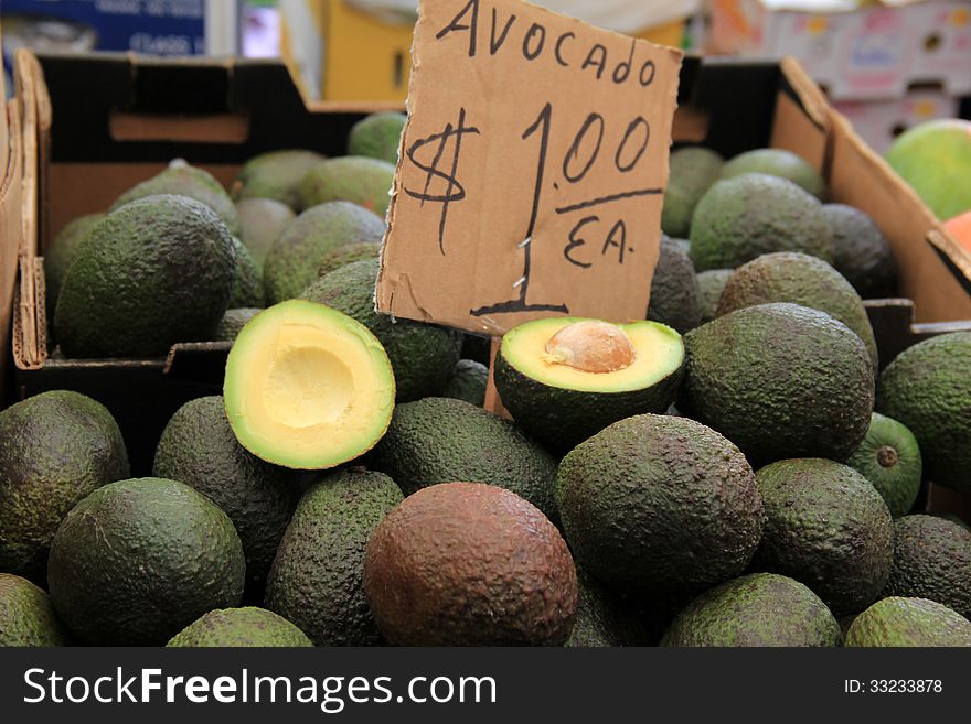 Fresh avocados piled high at farmers market