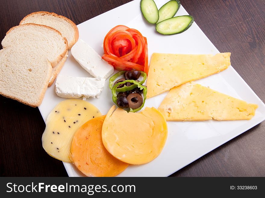 Cheese and olive, tomato platter with vegetable and herbs. Cheese and olive, tomato platter with vegetable and herbs