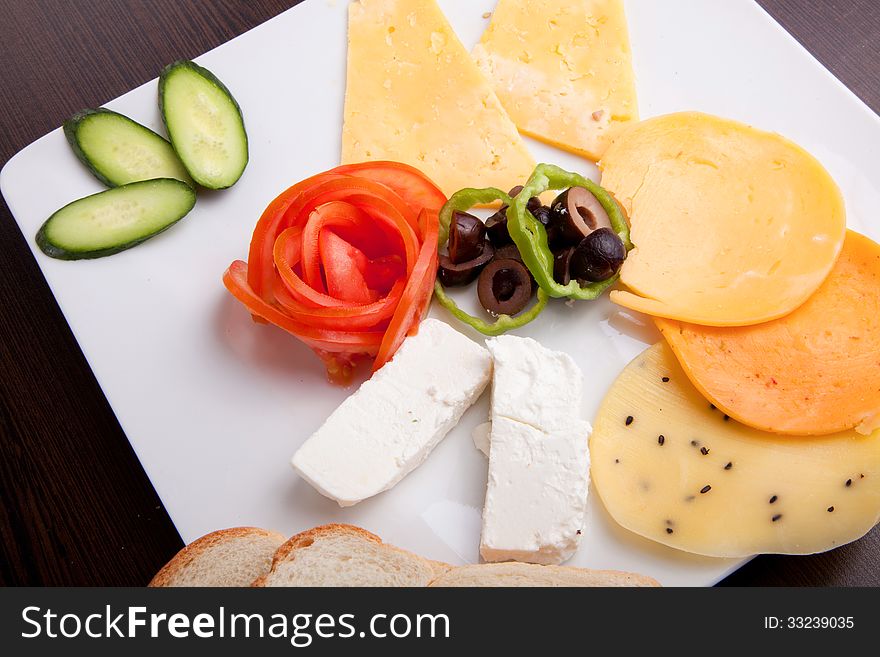 Cheese and olive, tomato platter with vegetable and herbs. Cheese and olive, tomato platter with vegetable and herbs