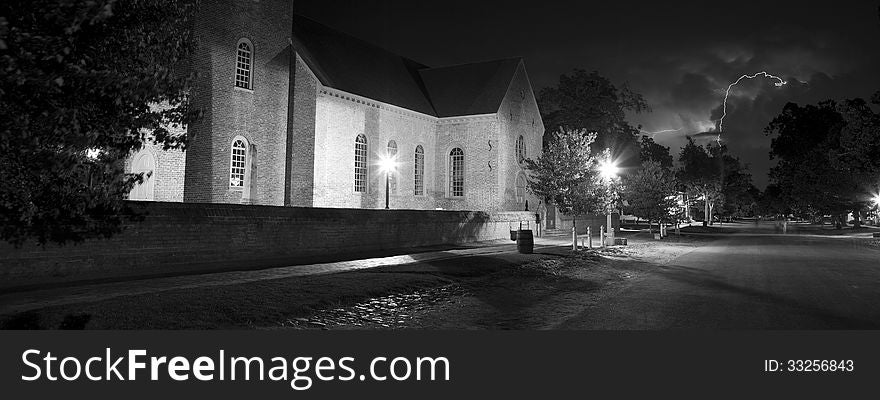 Black and white picture of Williamsburg, VA at night with lightning at the back. Black and white picture of Williamsburg, VA at night with lightning at the back