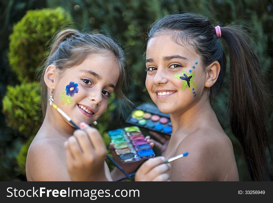 Playful young girls painted face. Playful young girls painted face