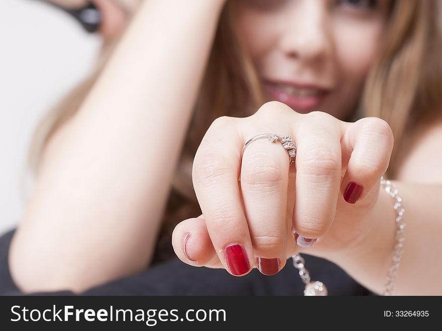 Woman hand close-up with blurred smiling face