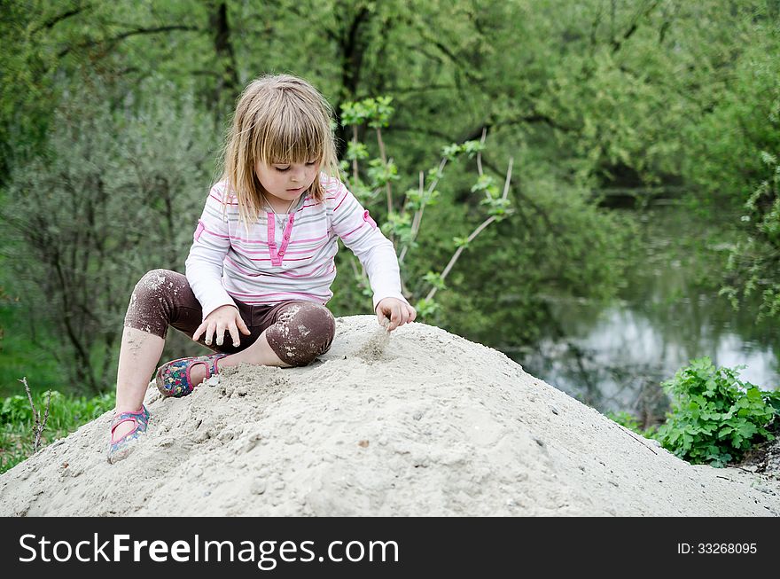 Girl plays in the sandbox. Girl plays in the sandbox