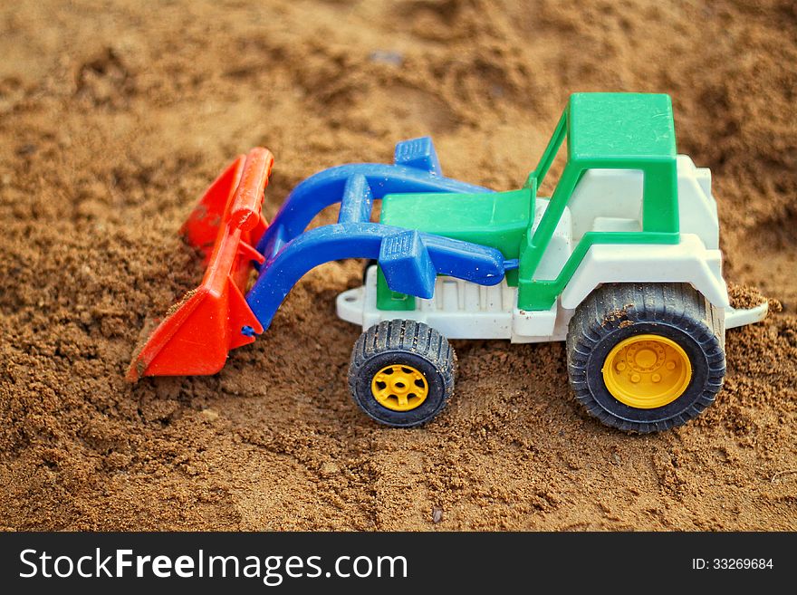 Toy Tractor in the sandbox