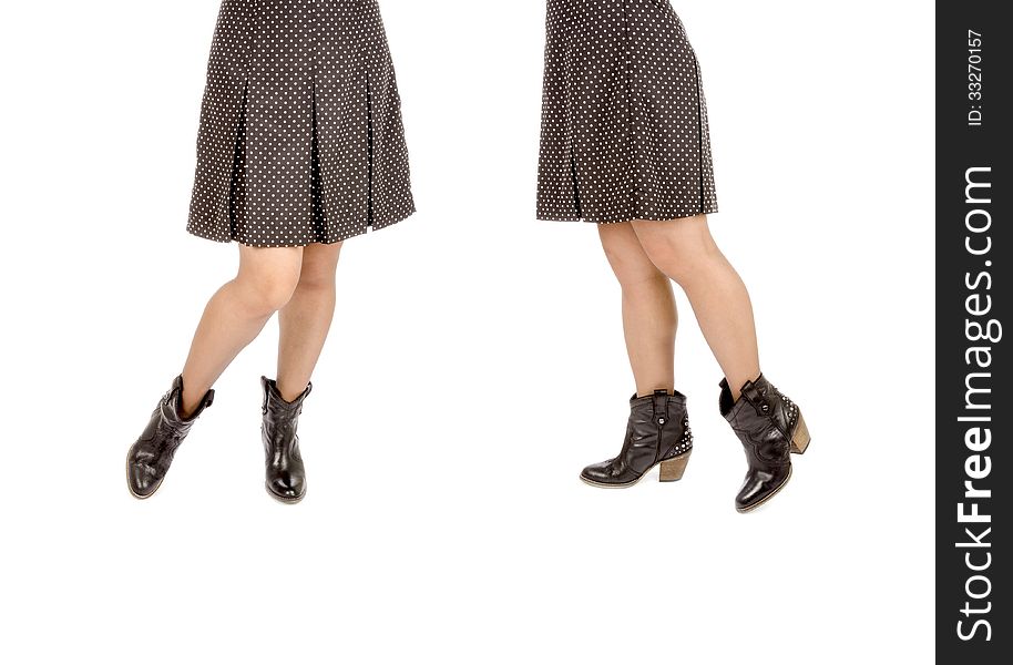 Woman Wearing Polka Dot Mini Skirt and Black Leather Cowboy Boots Isolated on White