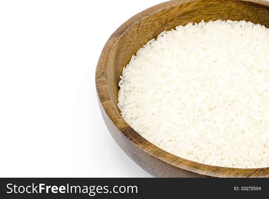 Rice on wood bowl isolated on white background