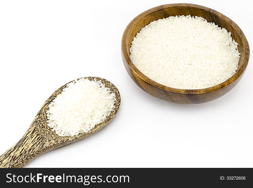 Rice on wood bowl isolated on white background