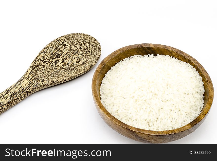 Rice on wood bowl isolated on white background