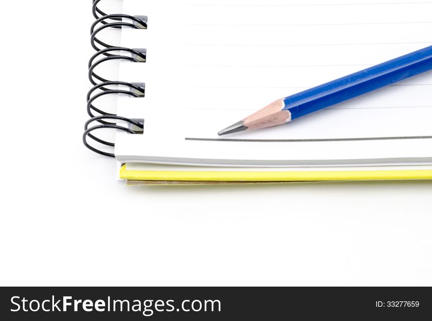 Notebook an blue pencil isolated on white background. Notebook an blue pencil isolated on white background