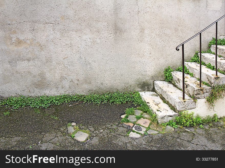 Old damaged stone staircase and old damaged wall. Old damaged stone staircase and old damaged wall