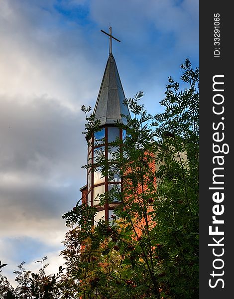 Dome of the church is hidden behind branches of viburnum. Dome of the church is hidden behind branches of viburnum