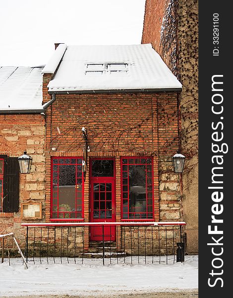 Old pub with red windows and a door in winter. Old pub with red windows and a door in winter