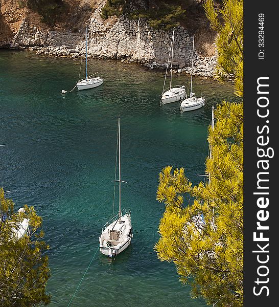 Yachts moored in the crystal clear waters of luminy calanque, near marseille, france. Yachts moored in the crystal clear waters of luminy calanque, near marseille, france