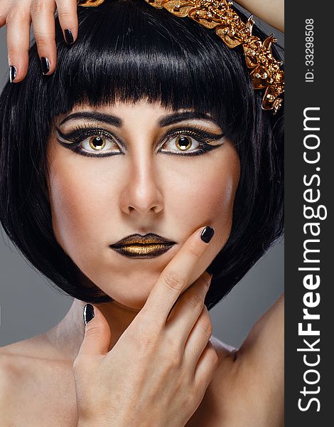 Close-up portrait of a beautiful girl with an evening make-up and jewelery