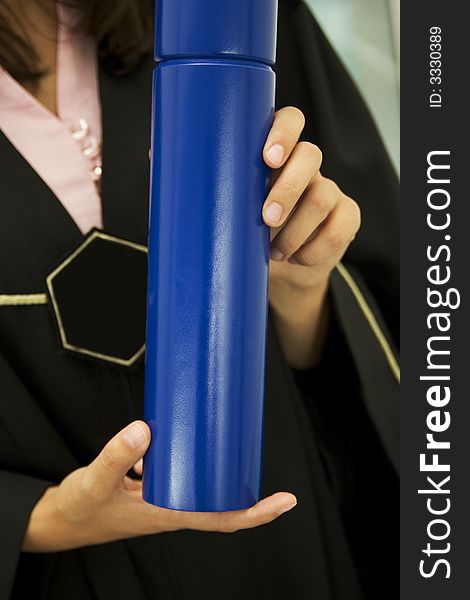 Student holding blue diploma in her hands