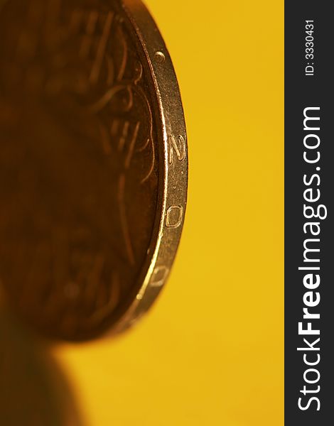 Close-up of coins on yellow background, macro (shallow DOF)