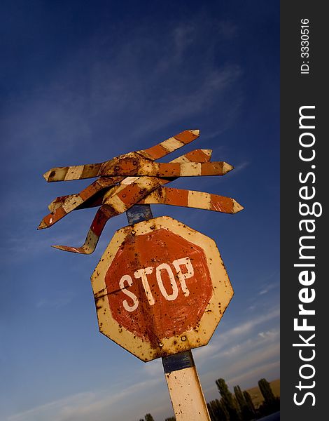 Stop on the road and blue sky in the background. Stop on the road and blue sky in the background