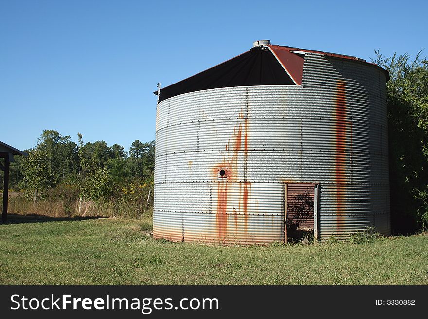 Rusty old Crop Storage bin with blue sky