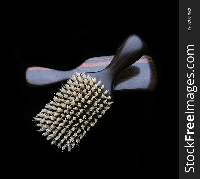 Men's comb. Expensive wooden comb isolated on the black color.