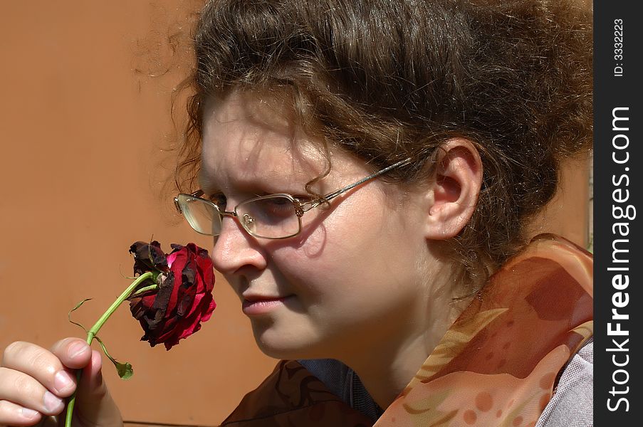 Young sad girl with single big rose. Young sad girl with single big rose