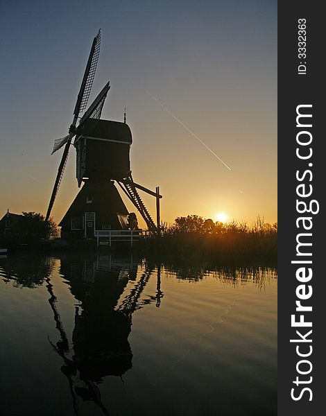 Recflection of a windmill in the sunrise. Recflection of a windmill in the sunrise