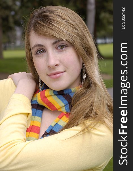 Young beautiful teen outdoors at the park. Has a fall or winter season look.