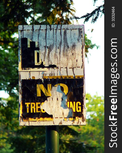 Old worn out no trespassing, private drive sign.