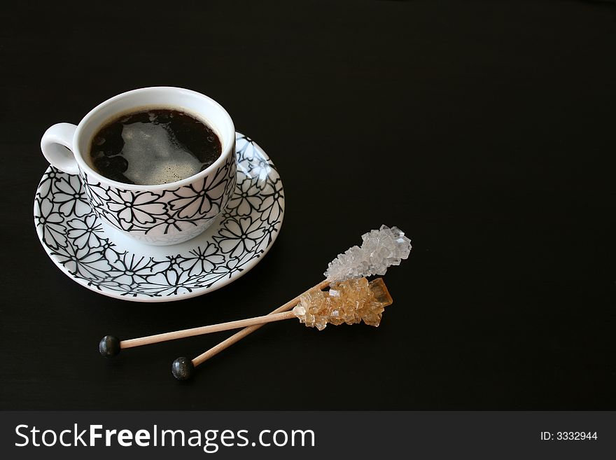 Black and white coffee cup with sugar crystals. Black and white coffee cup with sugar crystals
