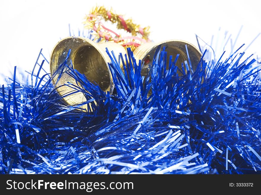 Two golden christmas bells on blue decorated  background.