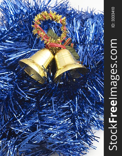 Two golden christmas bells on blue decorated background..