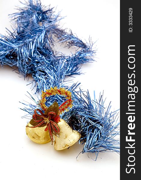 Two golden christmas bells on white background with blue decoration.