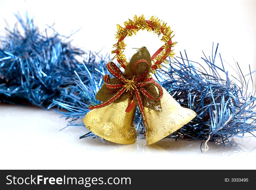 Two golden christmas bells on white background with blue decoration.