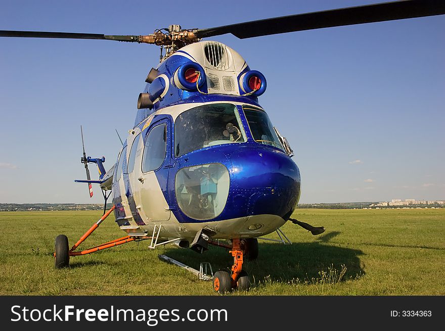 Blue helicopter on green grass