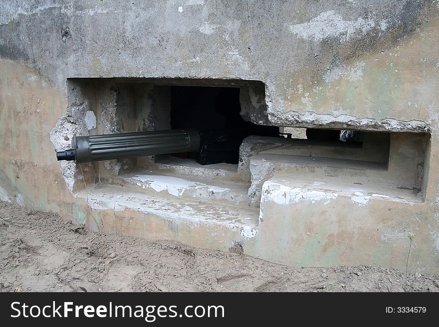 Old, retro machine gun in bunker window