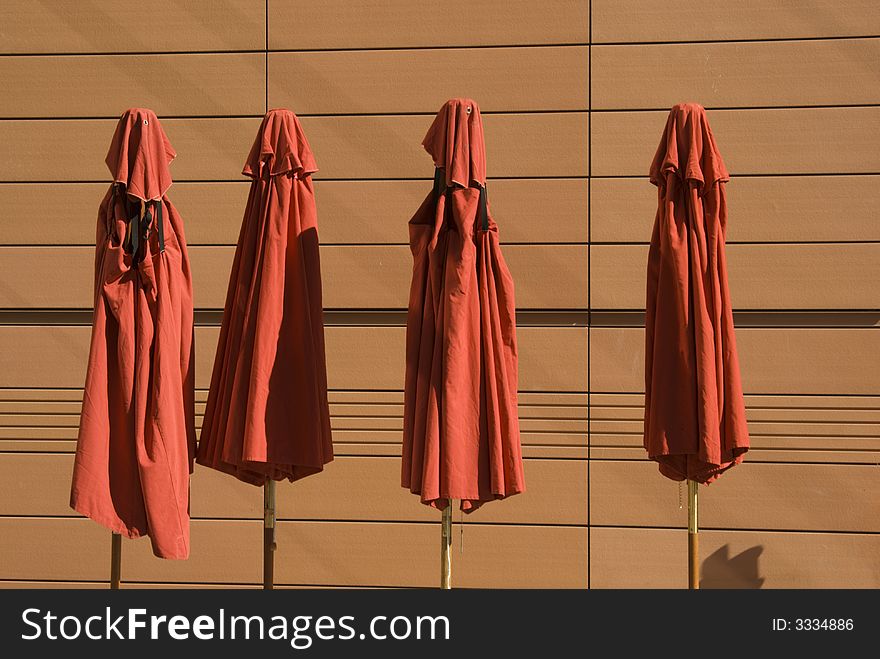 Folded umbrellas tucked away for storage until they are needed.