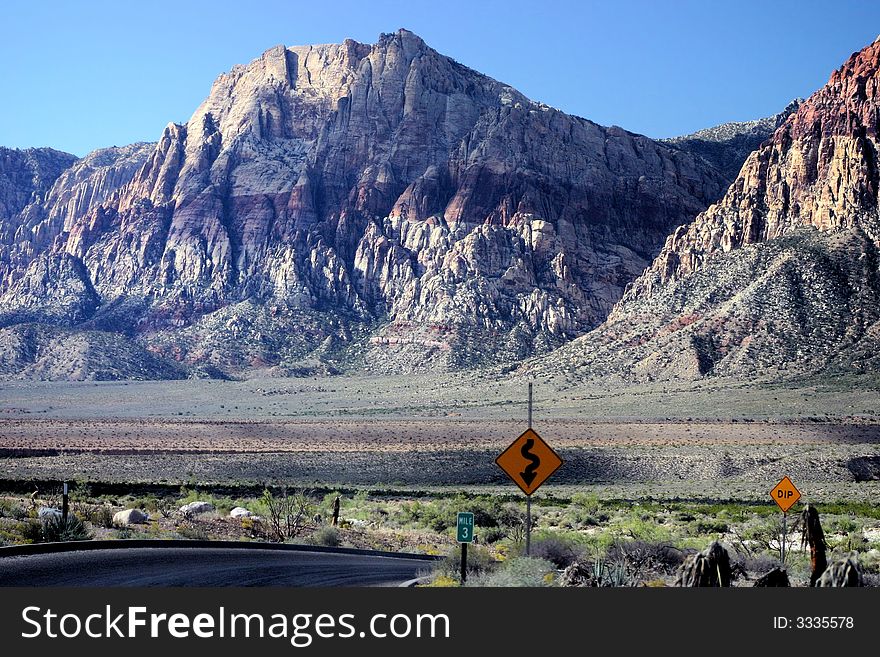 A winding road through the desert surrounded by mountains in Red Rock Canyon outside of Las Vegas, Nevada. A winding road through the desert surrounded by mountains in Red Rock Canyon outside of Las Vegas, Nevada.