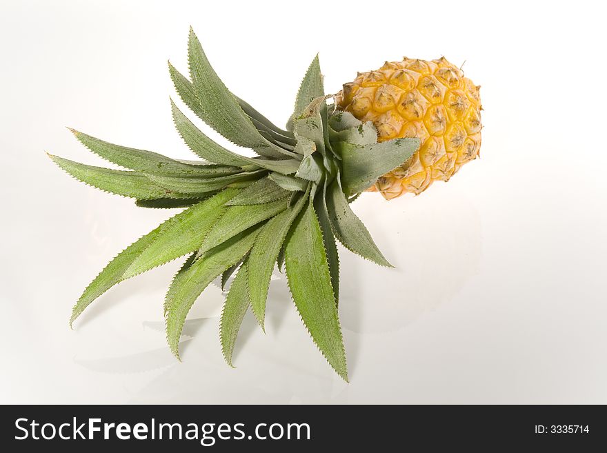 Tropical fruit pineapple with green leaves on a white background. Stil-life. Object. Tropical fruit pineapple with green leaves on a white background. Stil-life. Object.