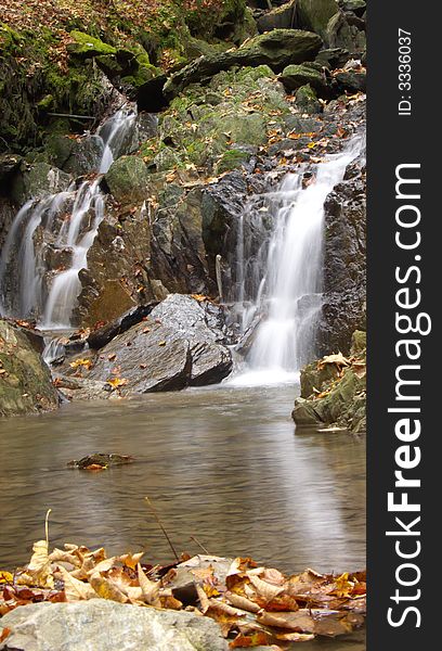 Small beck in a forest with a waterfall. Small beck in a forest with a waterfall