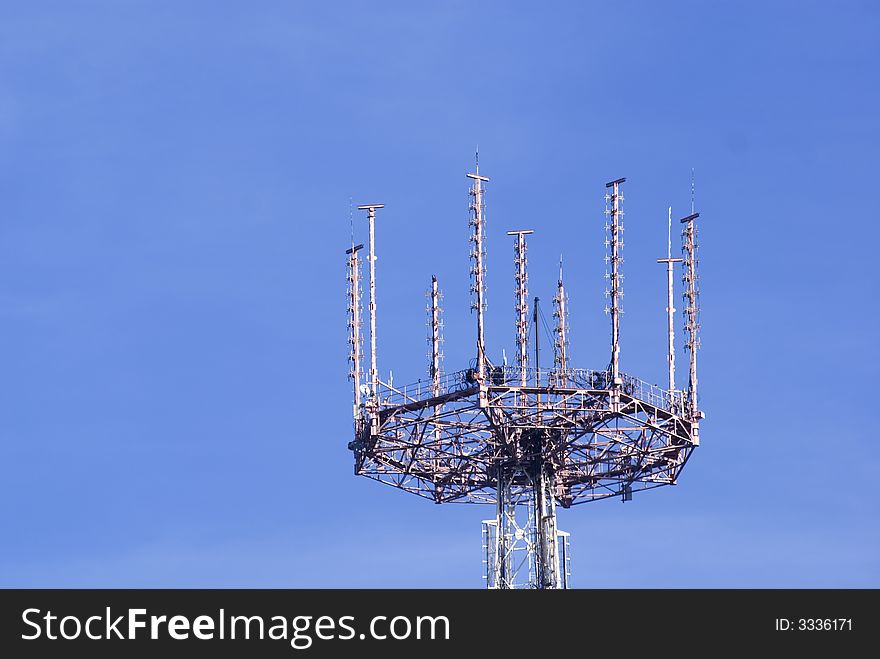 Telecommunication tower on the sky background