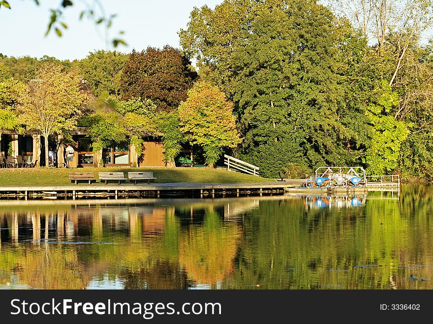 Colorful forest with shelter near a river under fall afternoon sunshine. Colorful forest with shelter near a river under fall afternoon sunshine.