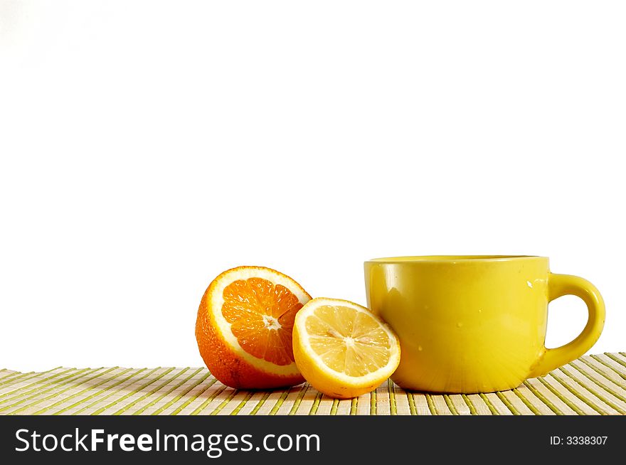 A yellow cup with tea and lemons
