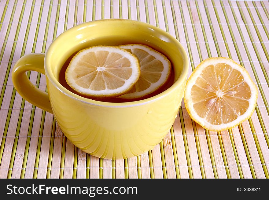 A cup with tea and lemons. A cup with tea and lemons