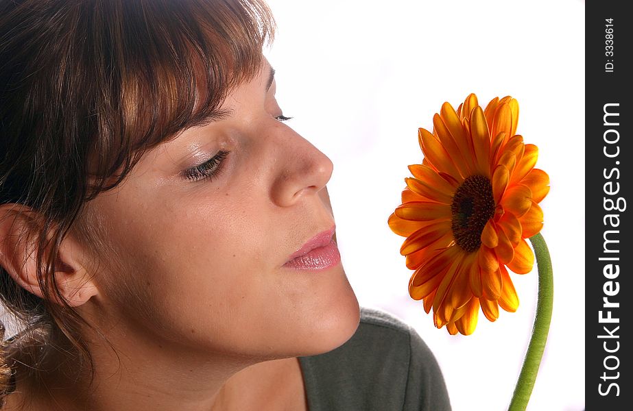 A young woman is smelling the scent of a beautiful flower!. A young woman is smelling the scent of a beautiful flower!