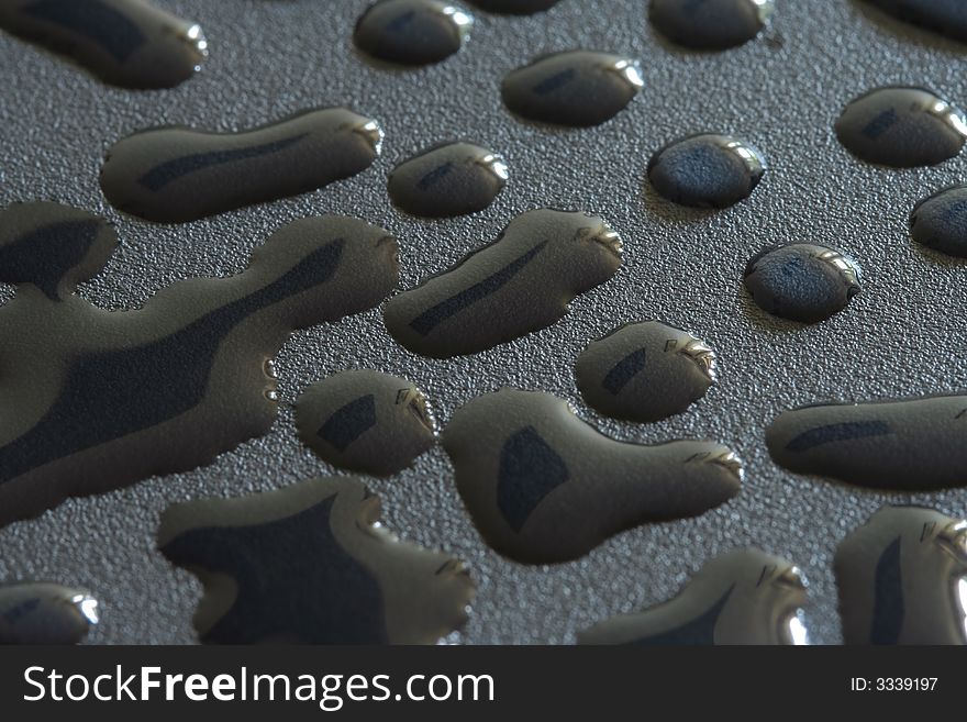 Water drops on rough black surface