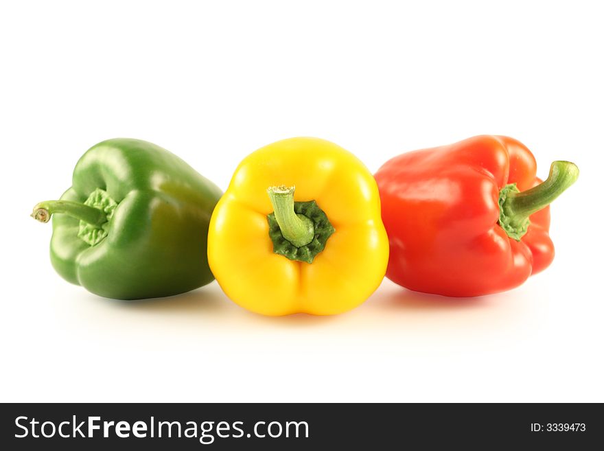 Three multi-coloured pepper isolated on white