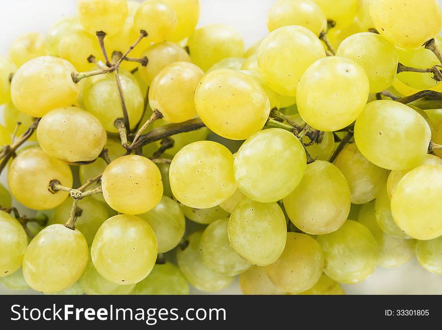 Bunch of yellow grapes closeup as a background