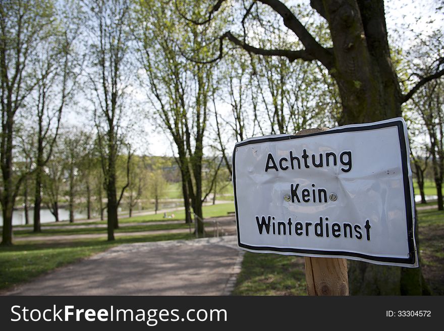Traffic sign Kein Winterdienst in springtime in the park. Traffic sign Kein Winterdienst in springtime in the park
