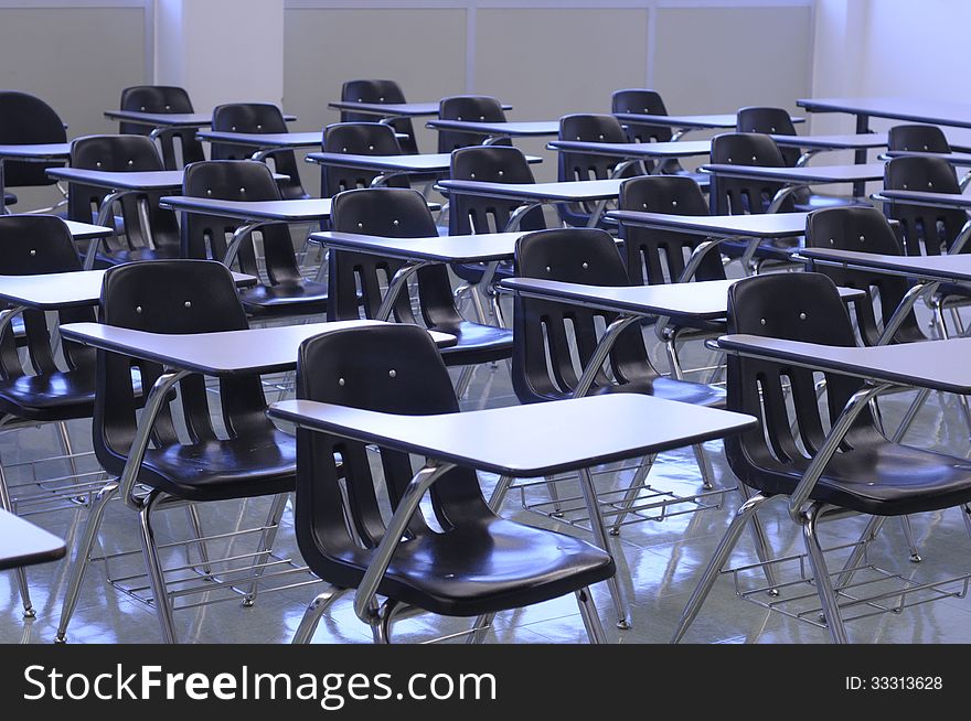Clean classroom with black tabchairs, shiny floor and white boards ready for back to school. Clean classroom with black tabchairs, shiny floor and white boards ready for back to school