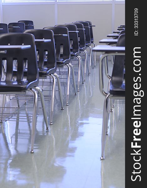 Clean classroom with black tab-chairs, shiny floor ready for back to school. Clean classroom with black tab-chairs, shiny floor ready for back to school